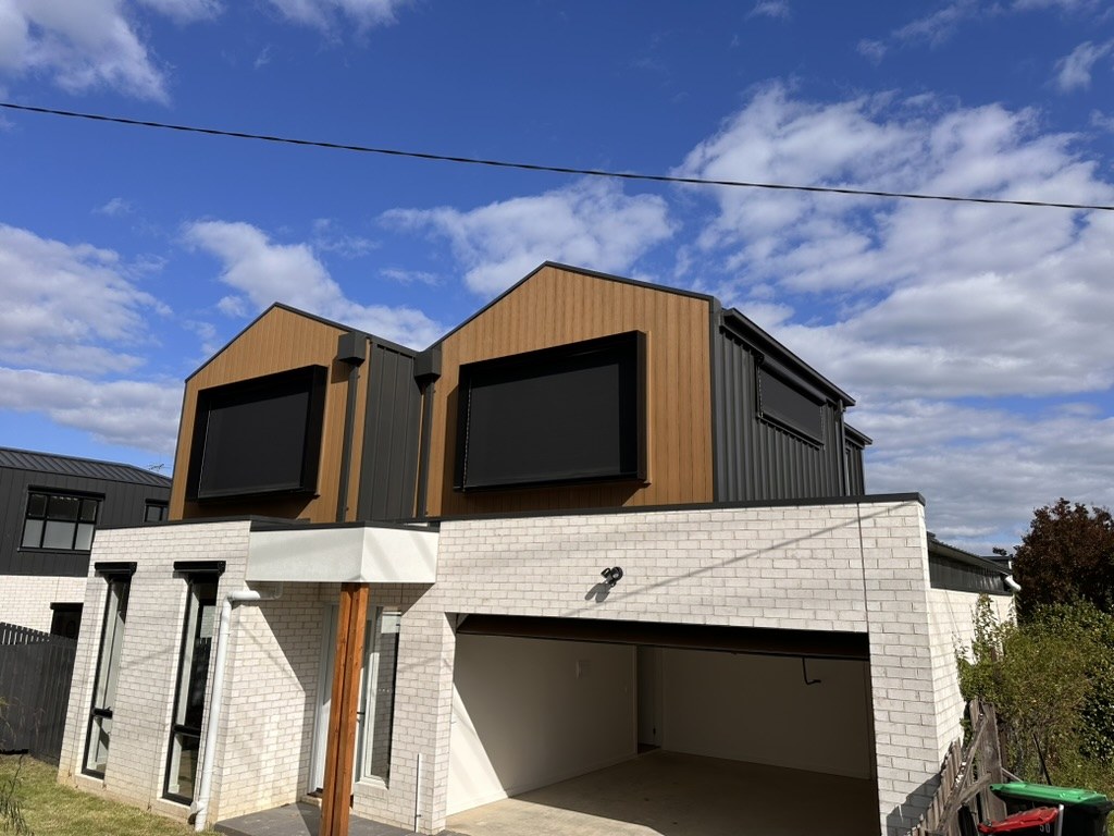 Doncaster home exterior with motorised wire guided blinds fitted to upper windows