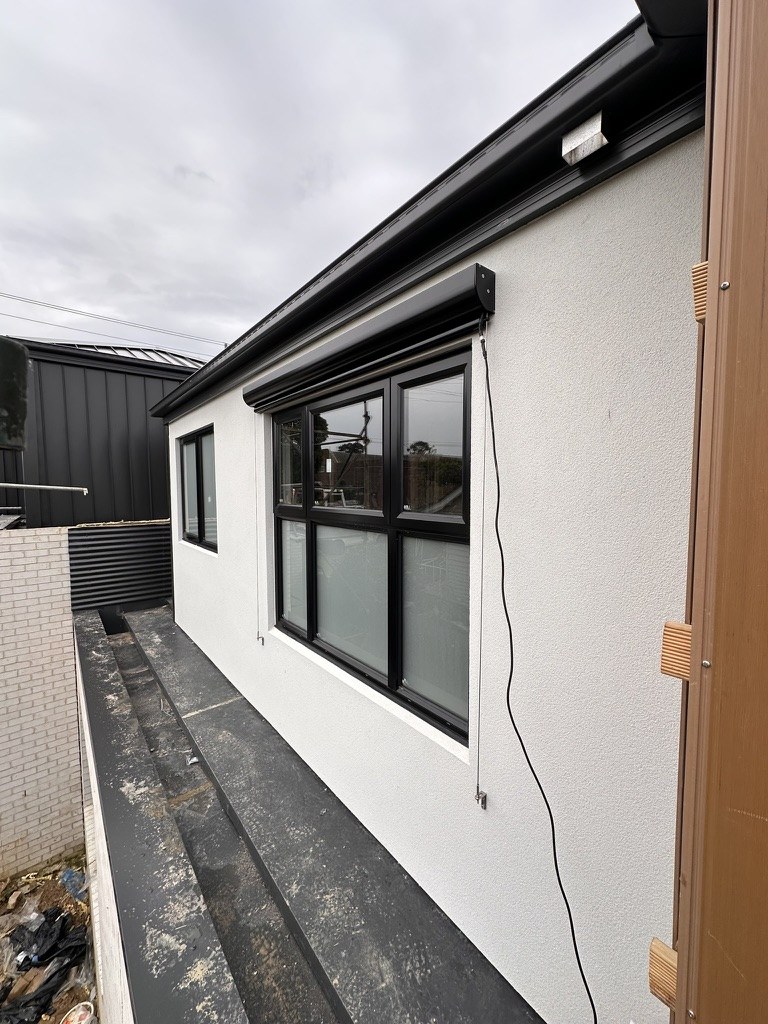 Close exterior window view of a motorised wire guided blind in Doncaster