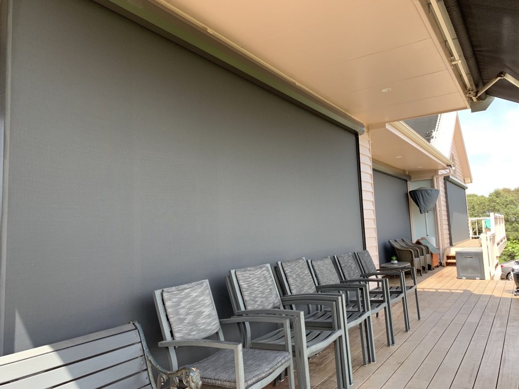 Motorised Ziptrak blinds enclosing a covered deck area in Rye