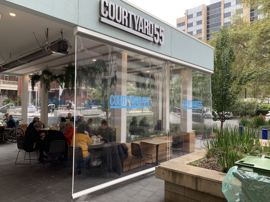 Clear PVC straight drop blinds enclosing a cafe frontage