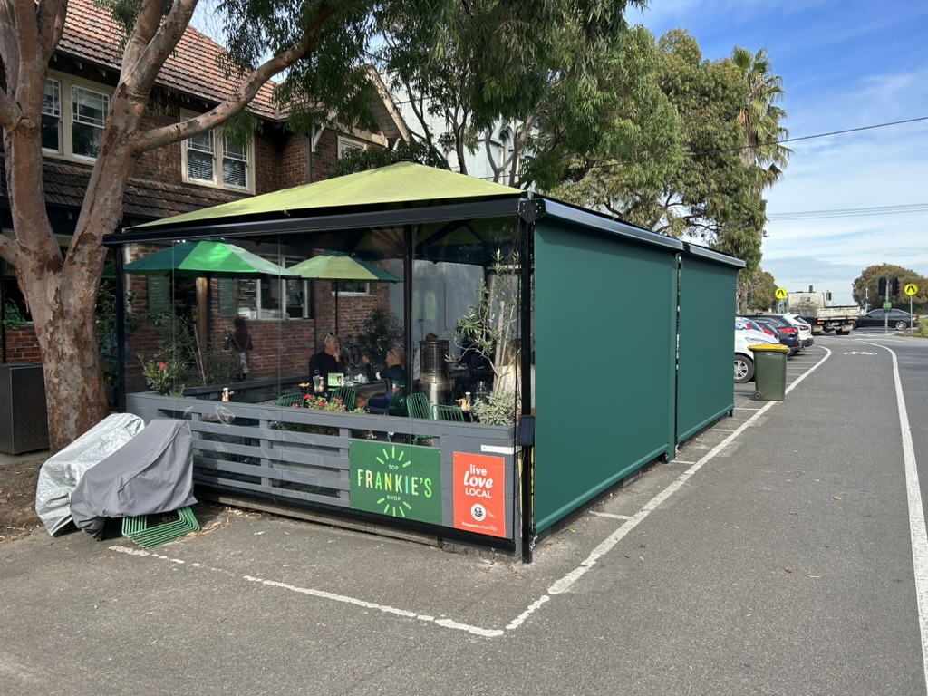 Straight drop blinds installed on an outdoor cafe enclosure