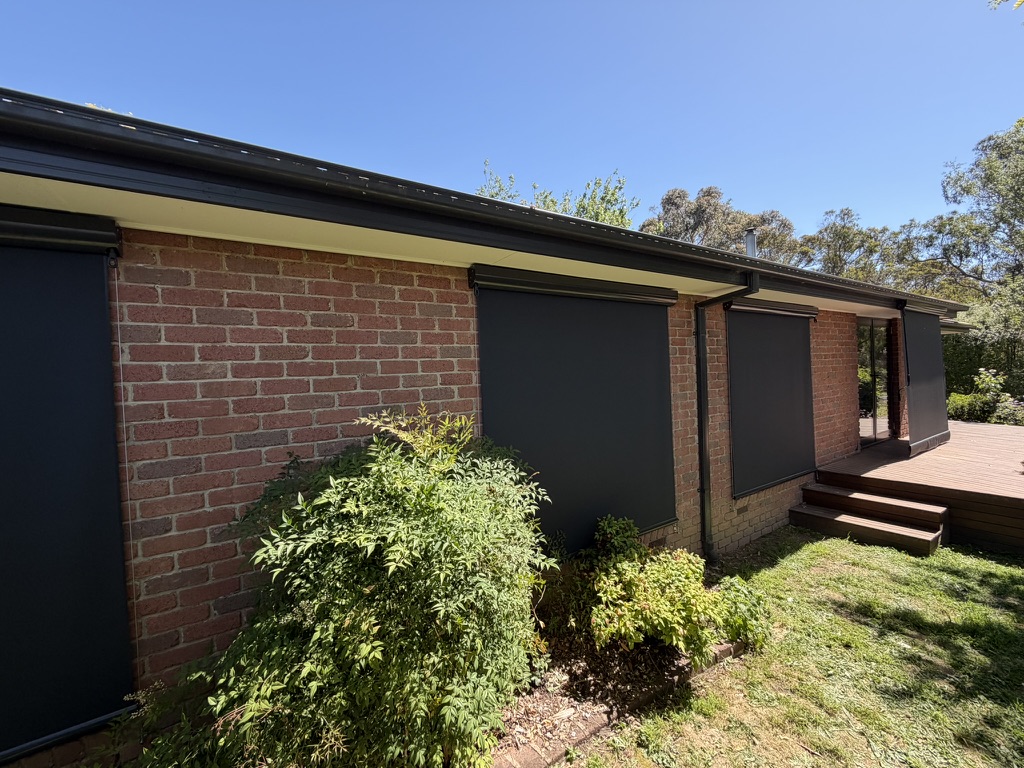 Multiple wire guided blinds fitted to a brick home