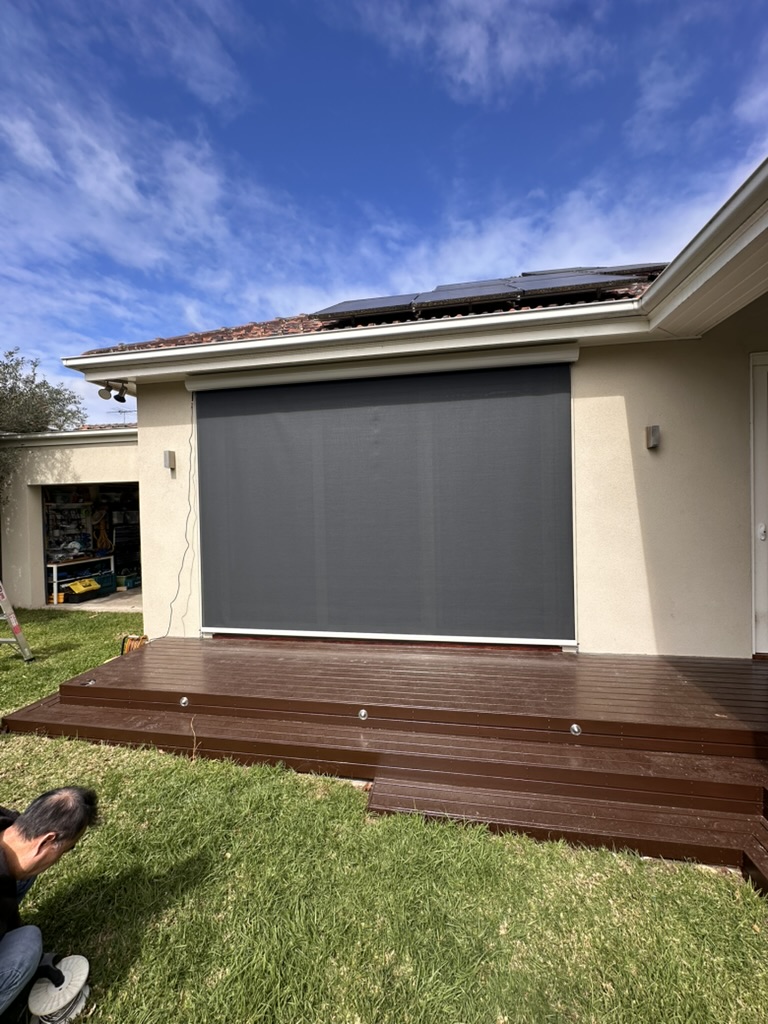 Large wire guided mesh blind fitted over a deck opening