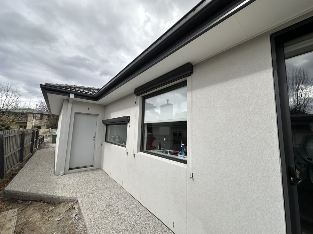 Wire guided blinds installed directly in front of exterior windows