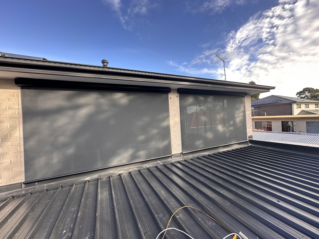 Upper-storey windows with wire guided mesh blinds lowered