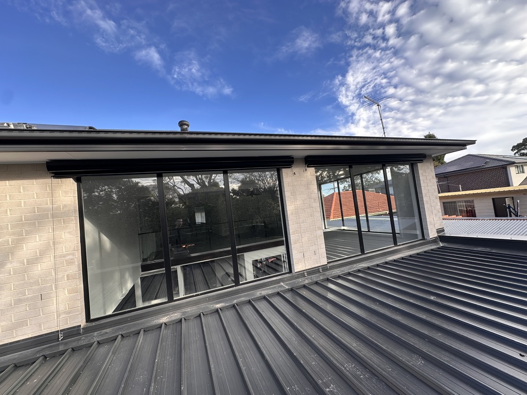 Upper-storey windows with wire guided blinds retracted
