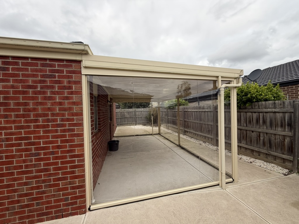 Clear PVC Ziptrak blinds enclosing a residential patio while preserving the view