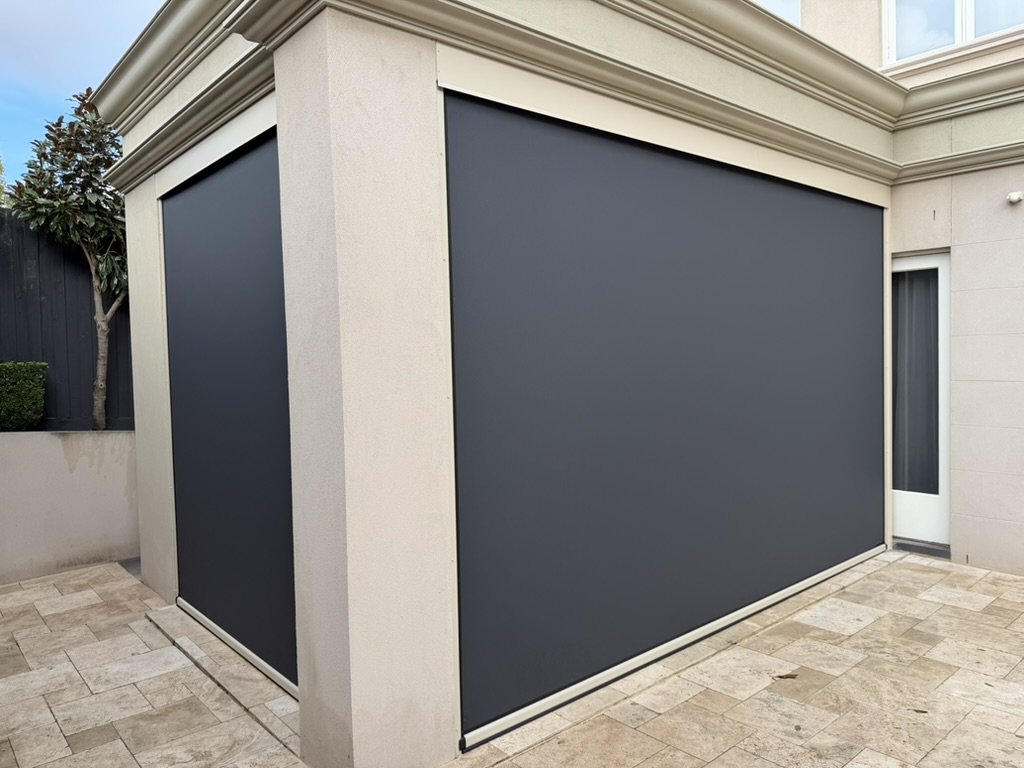Dark sunscreen mesh Ziptrak blinds enclosing a residential outdoor area