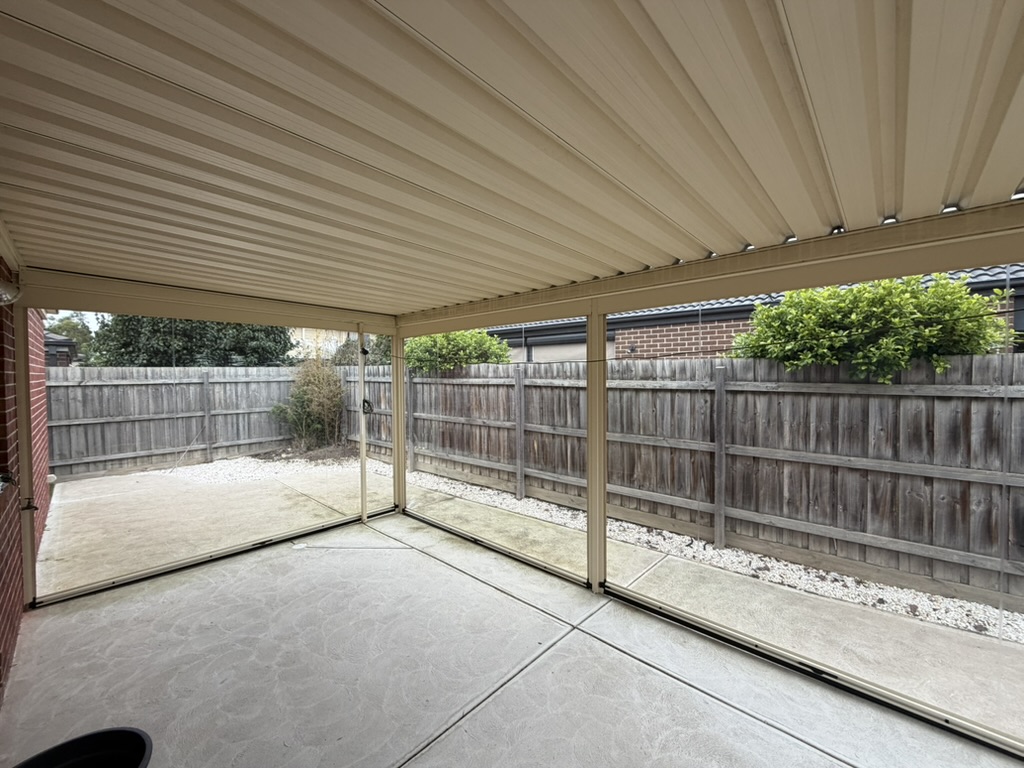 View from inside a patio enclosed with clear PVC Ziptrak blinds