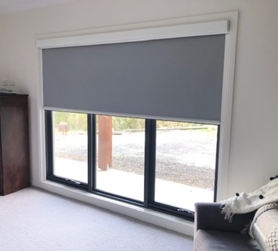 Grey Ziptrak Interior blind partially lowered over a living room window